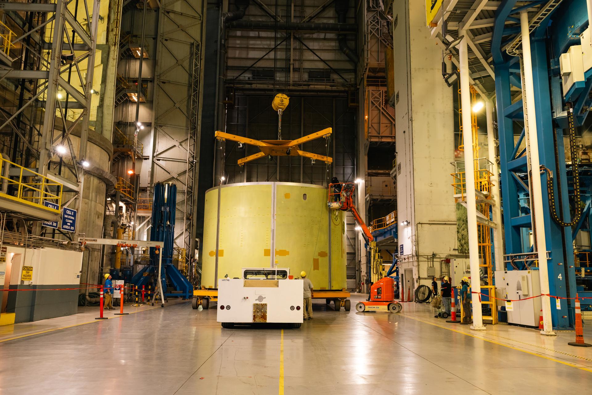 Teams at Michoud Assembly Facility in New Orleans load the engine section barrel into the vertical assembly center on Aug. 5, 2026. The engine section will be used on the SLS (Space Launch System) rocket’s core stage for the agency’s Artemis V mission. On the vertical assembly center tooling, teams will mate the flight hardware to a ring, which will serve as an attachment point for the liquid hydrogen tank later in the production process. The engine section is one of five major elements that make up the 212-foot-tall SLS rocket stage; and houses various avionic systems, the engine thrust structure, and four RS-25 engines. The core stage produces more than two million pounds of thrust to help launch NASA’s Orion spacecraft, astronauts, and supplies beyond Earth’s orbit and to the lunar surface for Artemis.